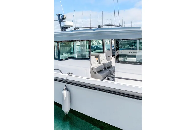 Slide: The Image of 2021 Axopar 37 XC Cross Cabin boat docked, showcasing sleek design and spacious interior. - 34