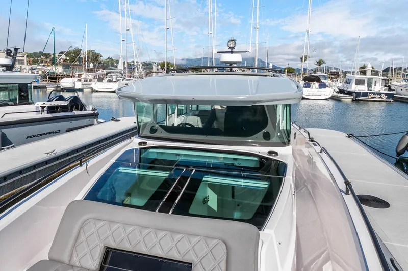 Slide: The Image of 2021 Axopar 37 XC Cross Cabin boat docked in a marina with other vessels. - 36