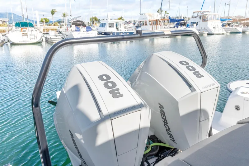 Slide: The Image of Twin Mercury 300 outboard engines on a 2021 Axopar 37 XC Cross Cabin boat in marina. - 37