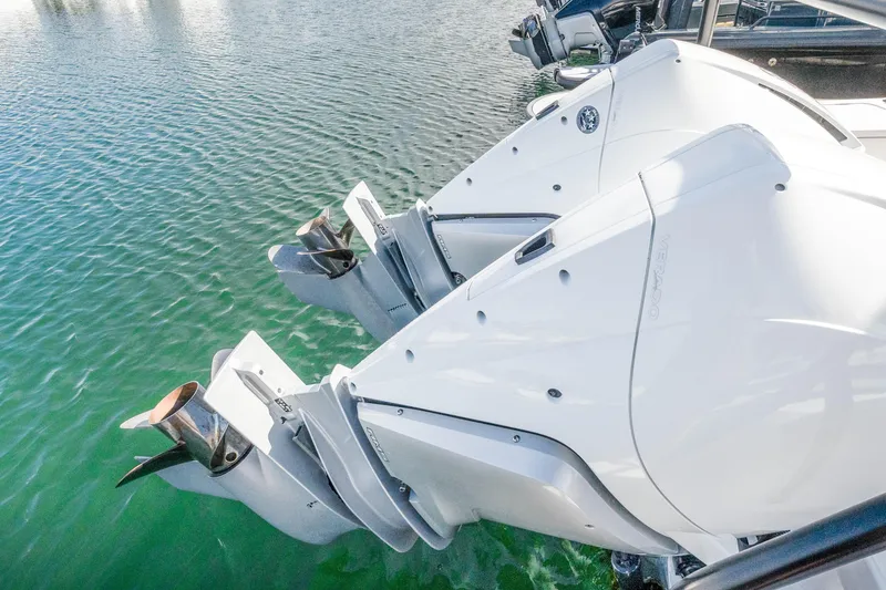 Slide: The Image of Twin outboard engines on a 2021 Axopar 37 XC Cross Cabin boat in water. - 38