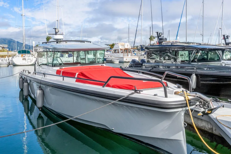 Slide: The Image of 2021 Axopar 37 XC Cross Cabin boat docked in a marina. - 40
