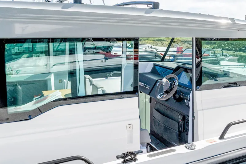 Slide: The Image of 2021 Axopar 37 XC Cross Cabin interior view with modern steering and dashboard. - 7