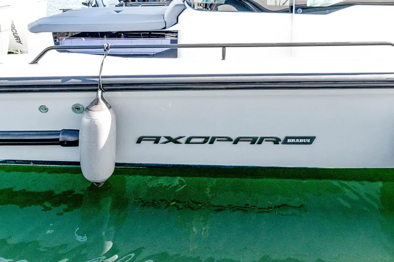 Slide: The Image of Side view of a 2021 Axopar 37 XC Cross Cabin boat on water. - 9