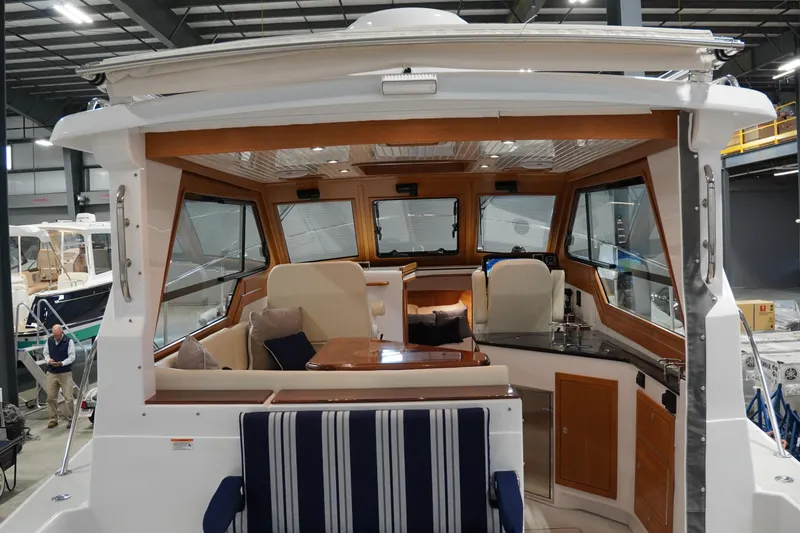 Slide: The Image of Interior view of 2024 True North 34 yacht, featuring elegant seating and wooden accents. - 20