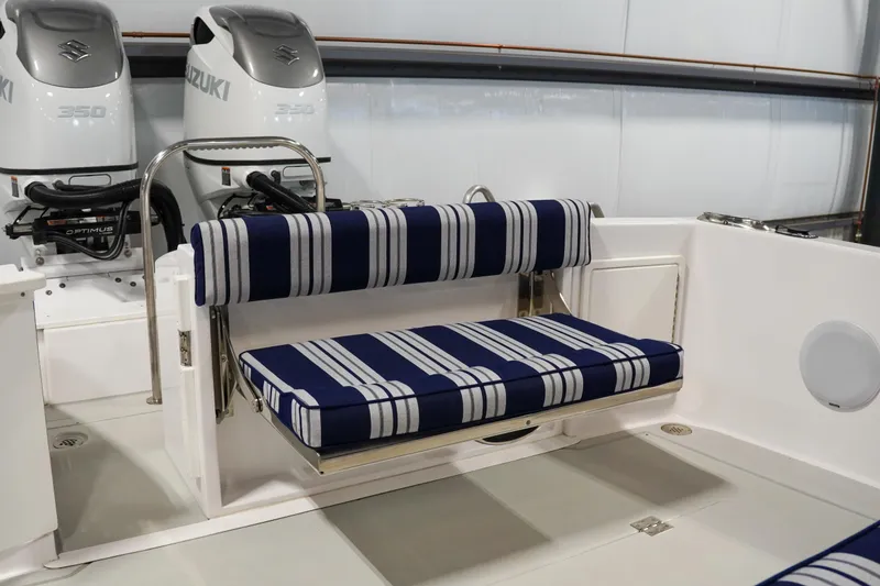 Slide: The Image of 2024 True North 34 boat interior with striped seating and dual Suzuki engines. - 27