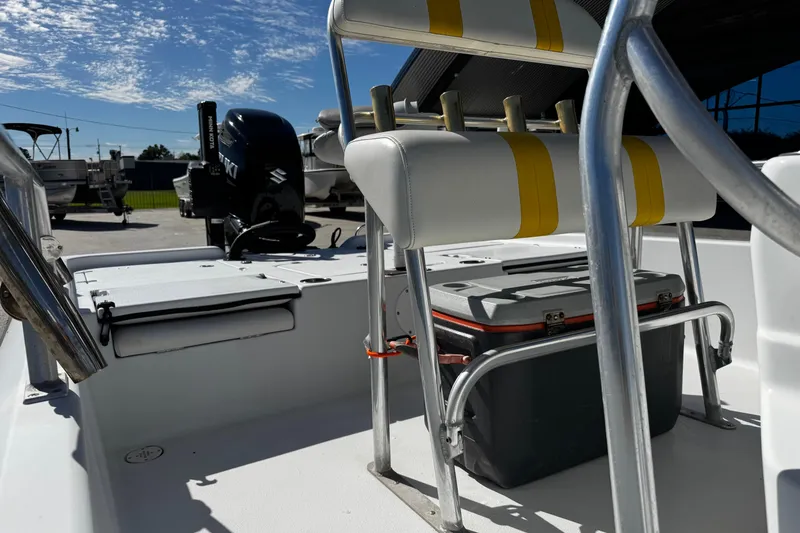 Slide: The Image of 2006 Champion 24 Bay Champ boat interior with seating and storage, featuring Suzuki outboard motor. - 12