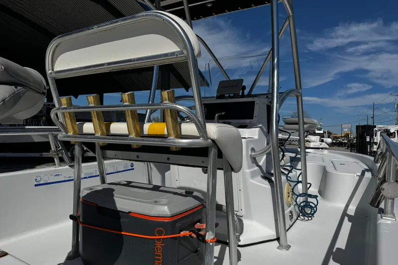 Slide: The Image of 2006 Champion 24 Bay Champ boat interior with seating and fishing rod holders. - 15