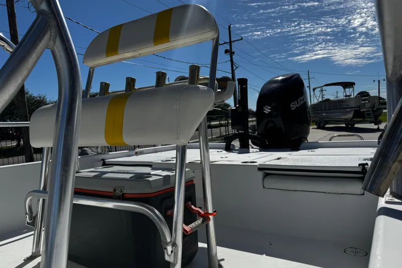 Slide: The Image of 2006 Champion 24 Bay Champ boat interior with seating and Suzuki outboard motor. - 16