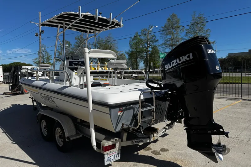 Slide: The Image of 2006 Champion 24 Bay Champ boat with Suzuki 300 HP engine on trailer. - 5