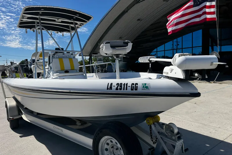 Slide: The Image of 2006 Champion 24 Bay Champ boat on trailer, American flag in background. - 6