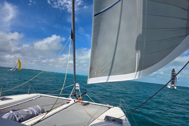 Slide: The Image of Sailing on a 2016 Outremer 45 catamaran with sails unfurled against a clear blue sky. - 107