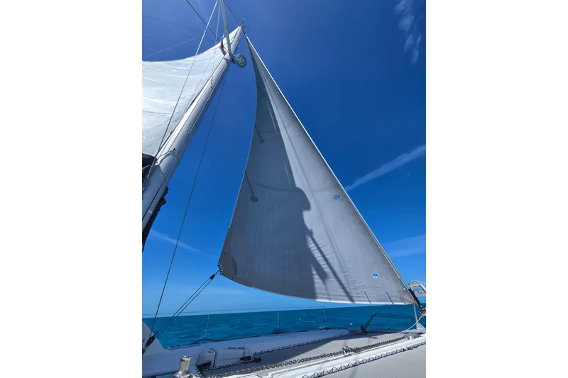 Slide: The Image of Colorful sail of a 2016 Outremer 45 catamaran against a clear blue sky. - 110
