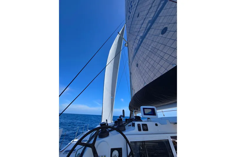 Slide: The Image of Sailing catamarans on turquoise waters, featuring a 2016 Outremer 45 model. - 115