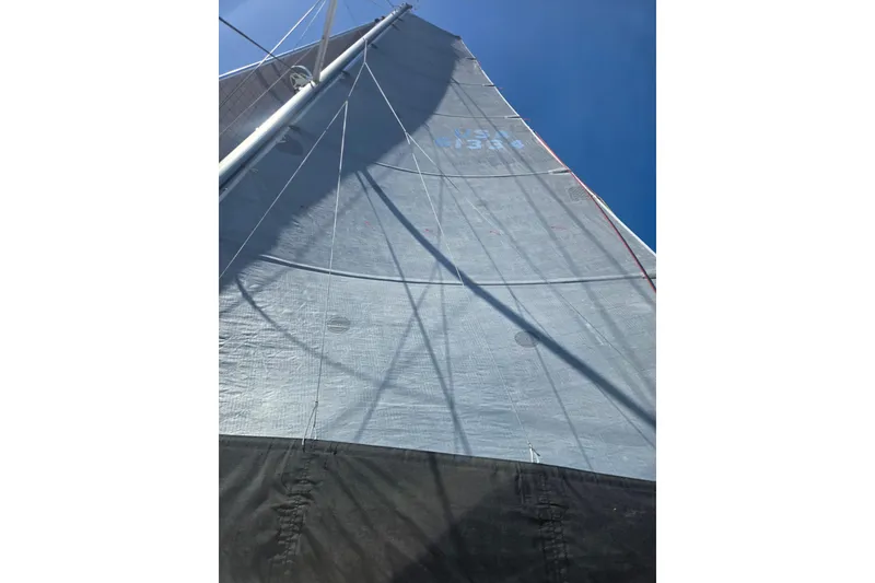 Slide: The Image of Sail of a 2016 Outremer 45 catamaran against a clear blue sky. - 14