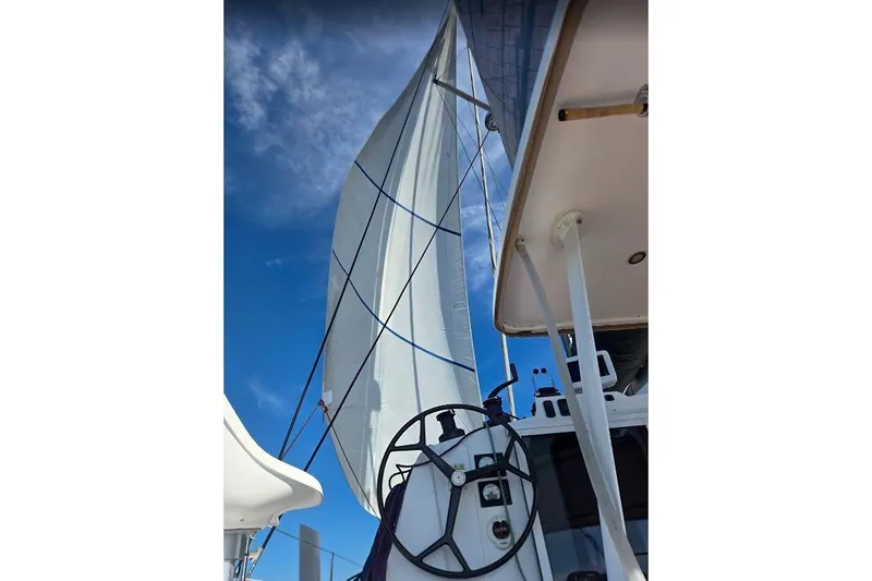 Slide: The Image of Sailing on a 2016 Outremer 45 catamaran with sails unfurled against a clear blue sky. - 17