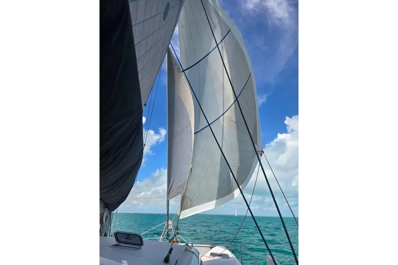 Slide: The Image of Outremer 45 catamaran sailing on turquoise waters under a clear blue sky, 2016 model. - 18