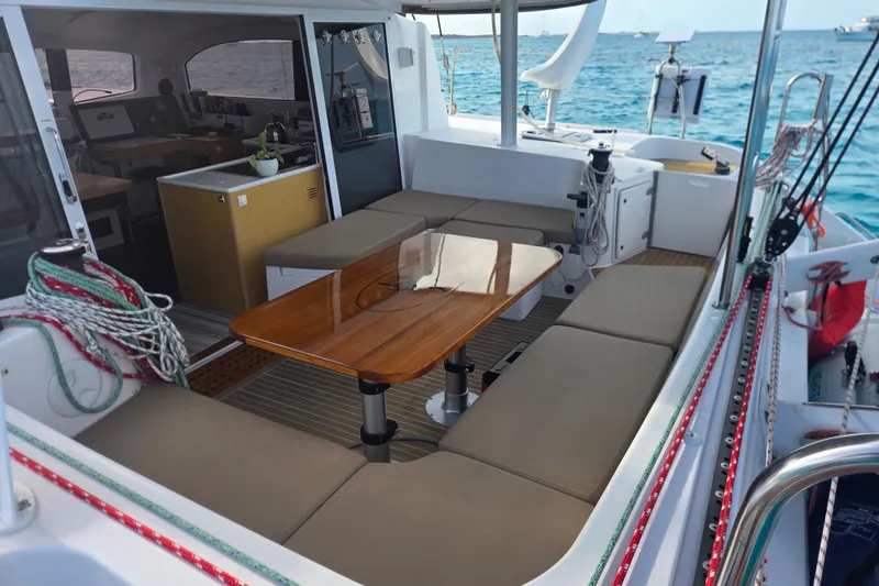 Slide: The Image of 2016 Outremer 45 catamaran interior with seating, table, and ocean view. - 27