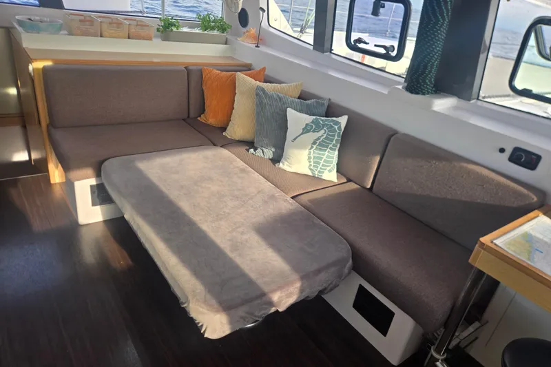 Slide: The Image of Cozy interior of 2016 Outremer 45 catamaran with plush seating and decorative pillows. - 29