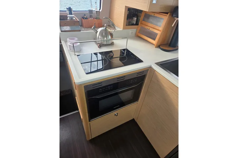 Slide: The Image of Modern kitchen in 2016 Outremer 45 yacht with stove, oven, and sleek cabinetry. - 31