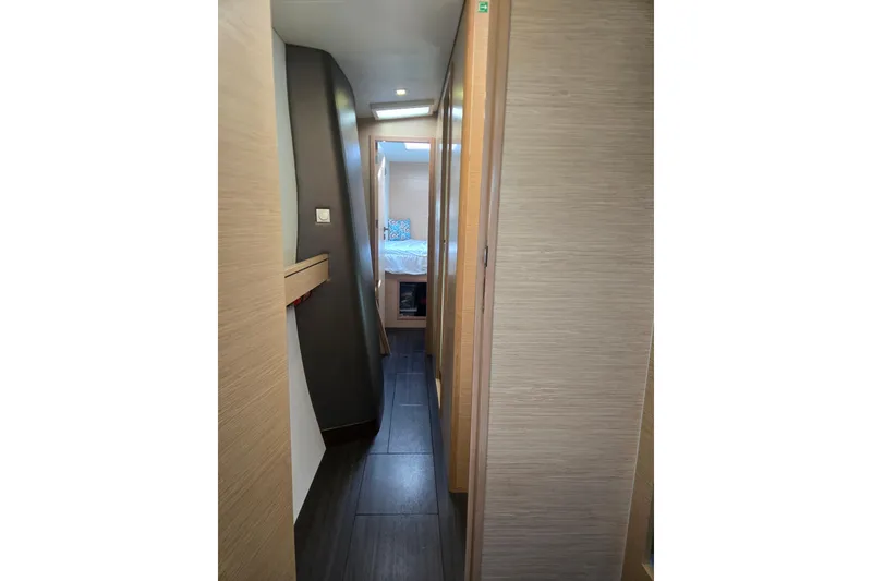 Slide: The Image of Interior hallway of 2016 Outremer 45 catamaran, leading to a cozy bedroom. - 36