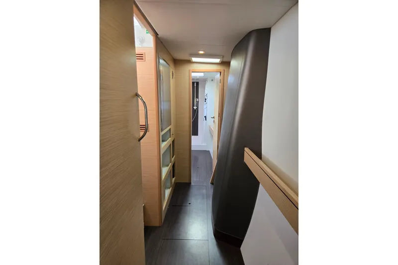 Slide: The Image of Interior hallway of a 2016 Outremer 45 catamaran, featuring modern wood finishes. - 37