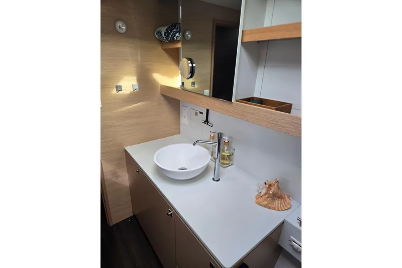 Slide: The Image of Modern bathroom interior on 2016 Outremer 45 yacht, featuring sleek sink and wooden accents. - 39
