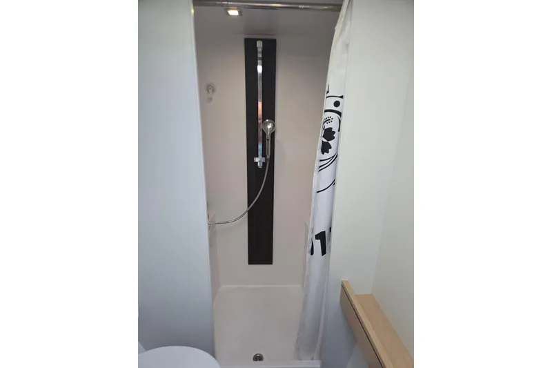 Slide: The Image of Shower area in 2016 Outremer 45 yacht, featuring modern fixtures and a curtain. - 42