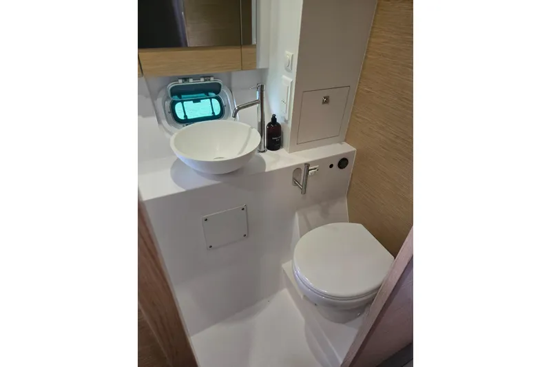 Slide: The Image of Modern bathroom in 2016 Outremer 45 yacht with sink, toilet, and porthole window. - 43