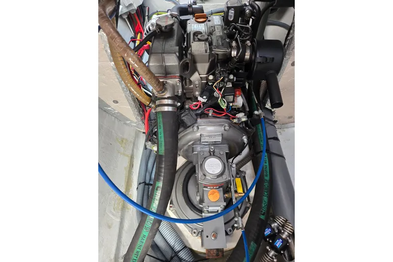 Slide: The Image of Engine compartment of a 2016 Outremer 45 catamaran, showcasing mechanical components and wiring. - 47