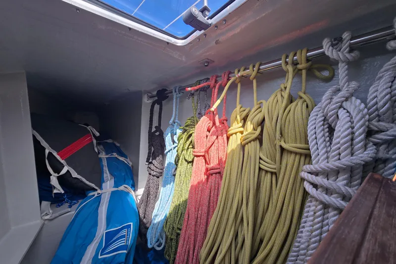 Slide: The Image of Colorful ropes and gear stored inside a 2016 Outremer 45 sailboat. - 51