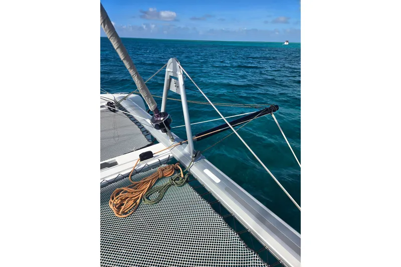 Slide: The Image of 2016 Outremer 45 catamaran deck with ropes, sailing on clear blue ocean. - 53