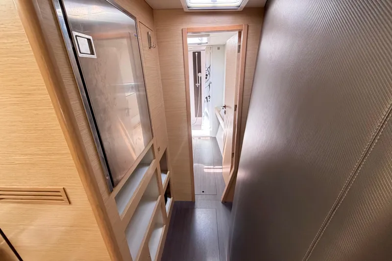 Slide: The Image of Interior hallway of a 2016 Outremer 45 catamaran, featuring modern wood finishes. - 62