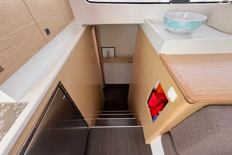 Slide: The Image of Interior of 2016 Outremer 45 yacht, featuring modern wooden cabinetry and stairs. - 70