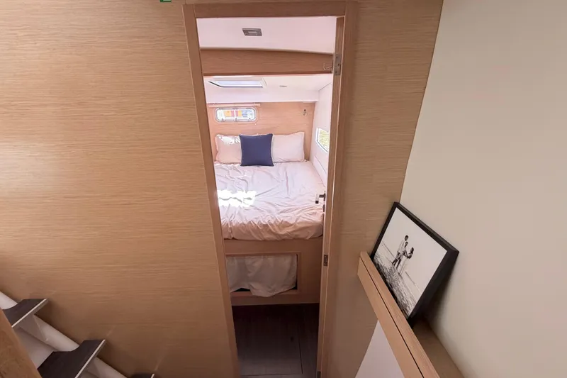 Slide: The Image of Cozy bedroom interior of 2016 Outremer 45 yacht with natural wood finish and soft bedding. - 73