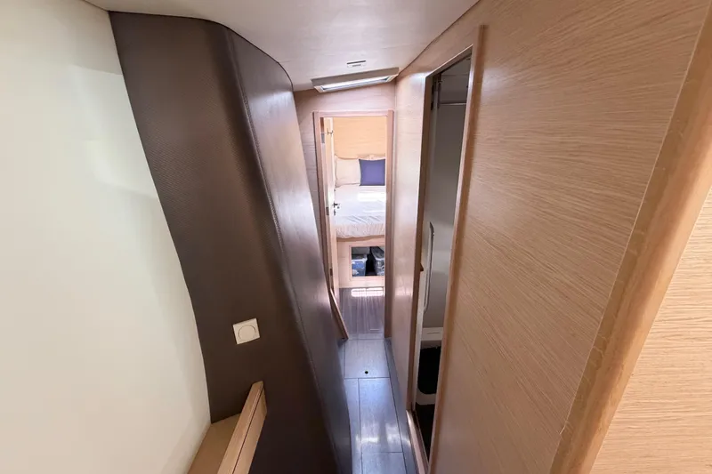 Slide: The Image of Interior hallway of 2016 Outremer 45 catamaran, featuring modern wood paneling. - 75