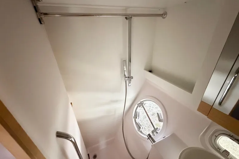 Slide: The Image of Shower area in 2016 Outremer 45 yacht with round window and modern fixtures. - 76