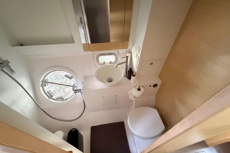 Slide: The Image of Compact bathroom in a 2016 Outremer 45 yacht with modern fixtures and porthole window. - 77