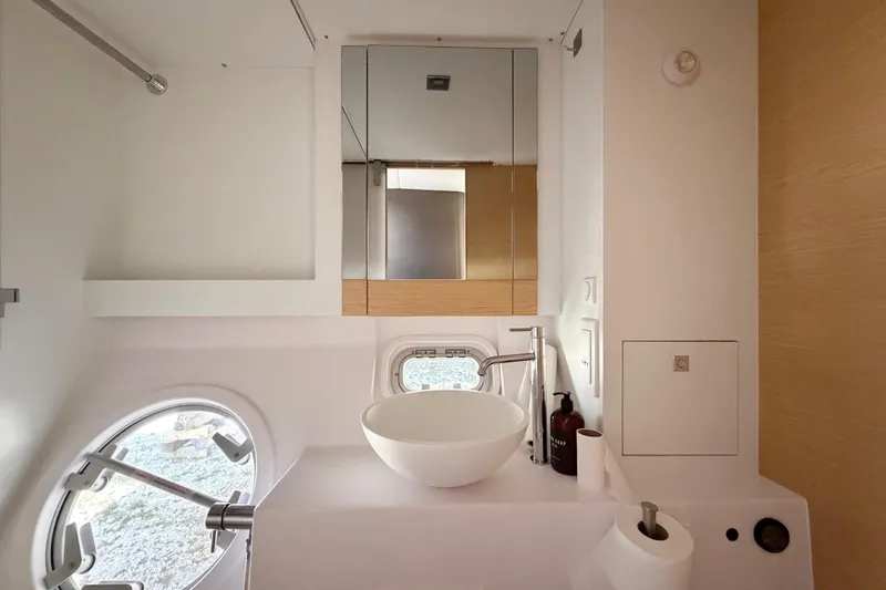 Slide: The Image of Modern bathroom interior of 2016 Outremer 45 yacht with sleek fixtures and round window. - 78