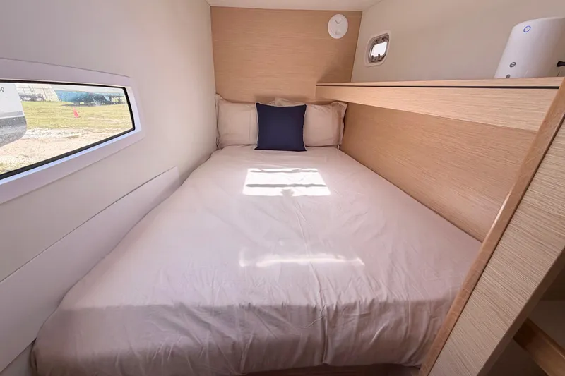 Slide: The Image of Cozy cabin interior of 2016 Outremer 45 catamaran with bed and window view. - 80