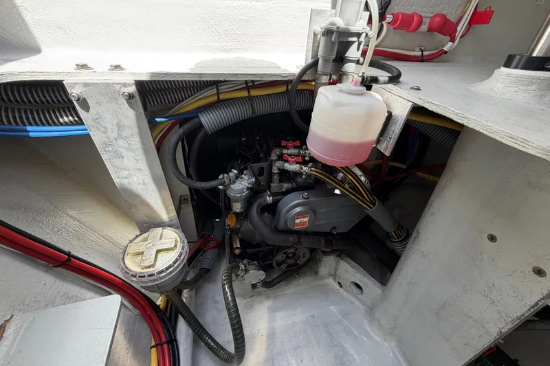 Slide: The Image of Engine compartment of a 2016 Outremer 45 catamaran, showcasing mechanical components and wiring. - 88