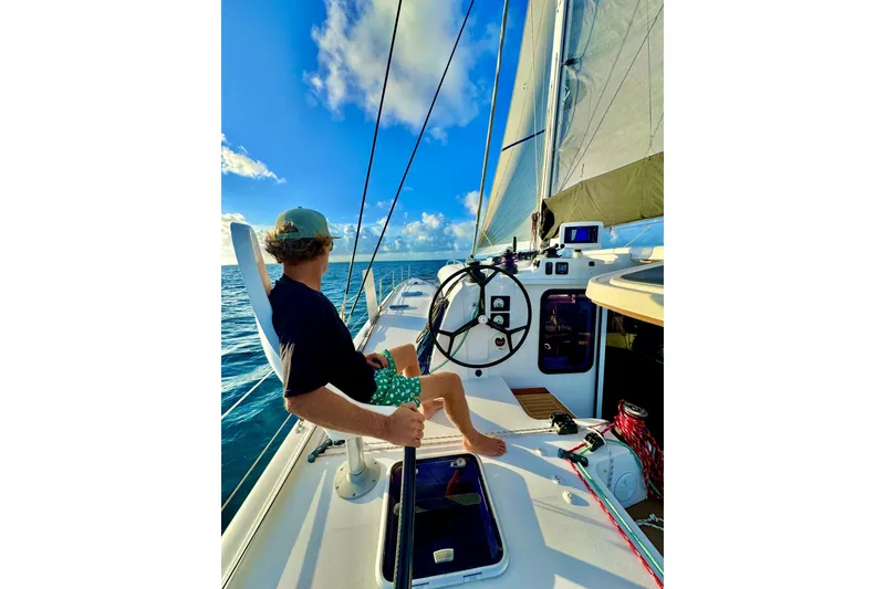 Slide: The Image of Man sailing on 2016 Outremer 45 catamaran, enjoying a sunny day at sea. - 9