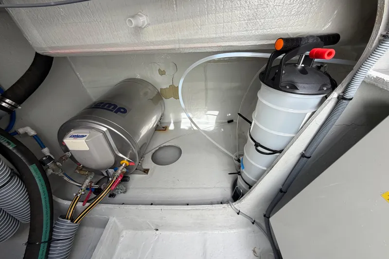 Slide: The Image of Engine compartment of a 2016 Outremer 45 yacht, featuring mechanical components and wiring. - 95
