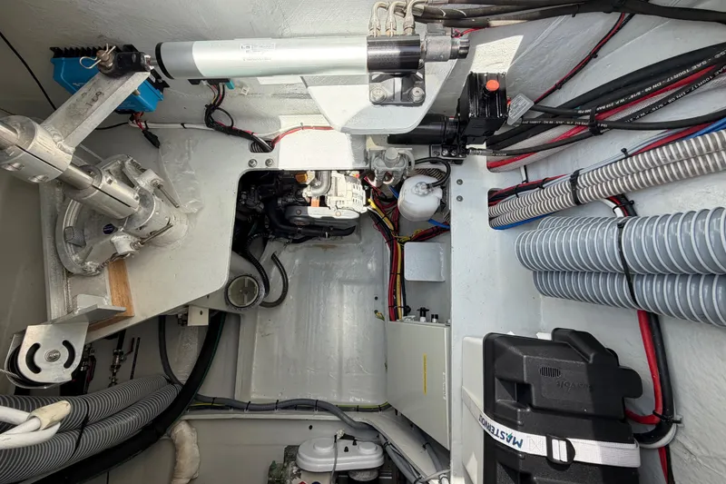 Slide: The Image of Engine compartment of a 2016 Outremer 45 catamaran, showcasing mechanical components and wiring. - 96