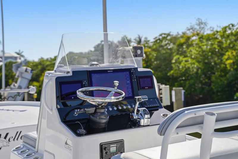 Slide: The Image of 2013 Yellowfin 24 Bay boat interior with logo and fishing rod holder. - 13