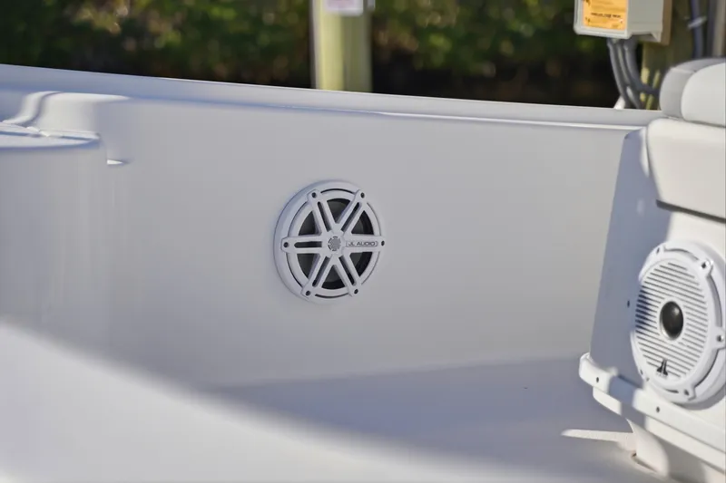 Slide: The Image of 2013 Yellowfin 24 Bay boat docked, featuring a Mercury outboard motor, against a scenic waterway backdrop. - 18