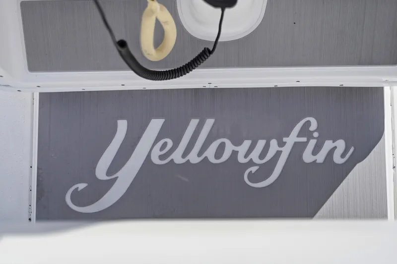 Slide: The Image of Open livewell on 2013 Yellowfin 24 Bay boat, dockside view. - 22