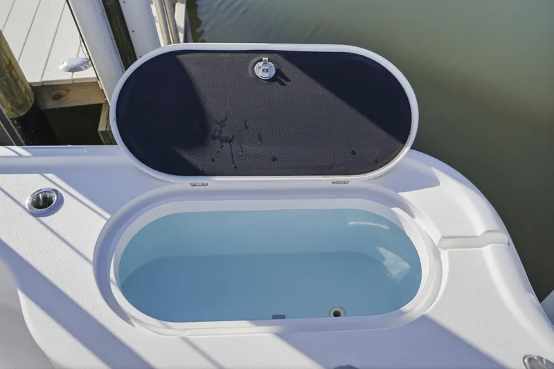 Slide: The Image of 2013 Yellowfin 24 Bay boat with seating and storage, docked by a calm waterway. - 23