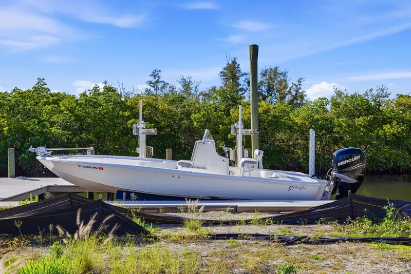 Slide: The Image of Close-up of a 2013 Yellowfin 24 Bay boat motor against a scenic backdrop. - 25