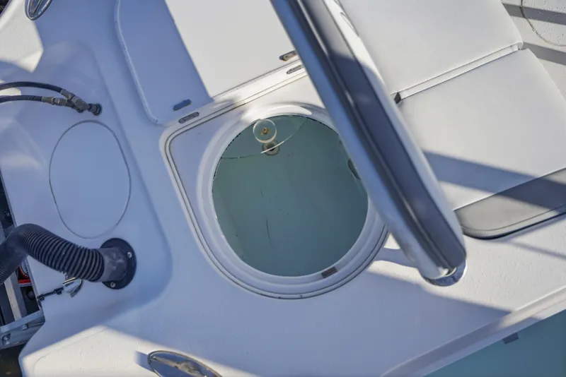 Slide: The Image of 2013 Yellowfin 24 Bay boat livewell and seating area, showcasing interior details. - 5