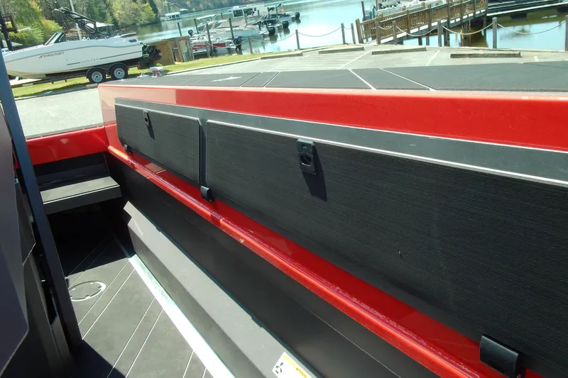 Slide: The Image of 2026 Stabicraft 2050 Frontier boat interior with red and black detailing at a marina. - 16